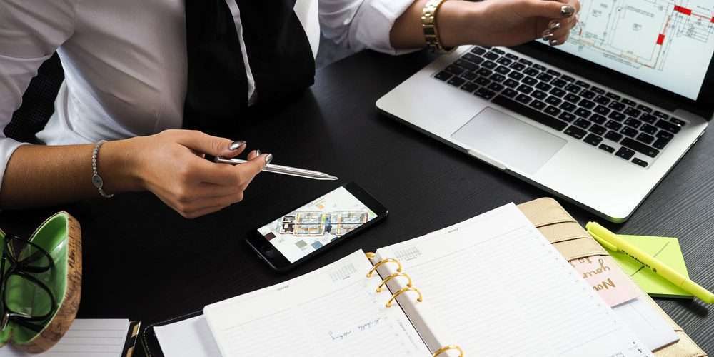 Property Manager with a laptop and smartphone
