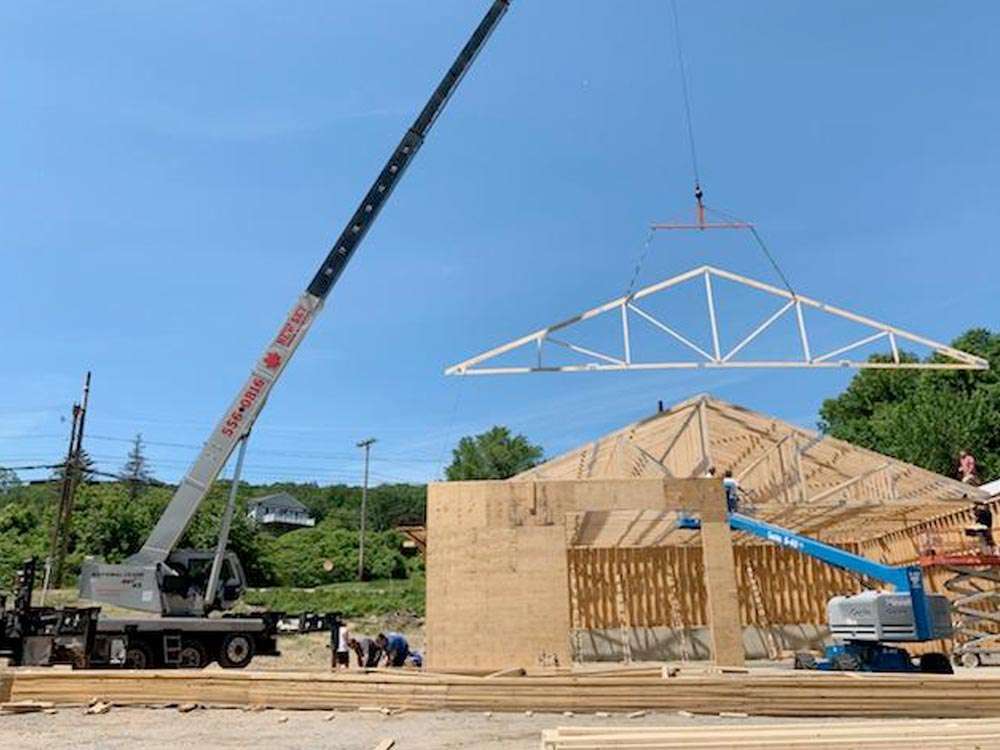 Construction Project with Crane onsite Crane setting the foundation of a roof